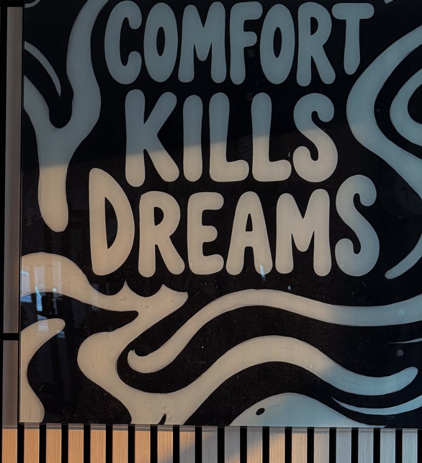 The Comfort Kills Dreams mural on the wall