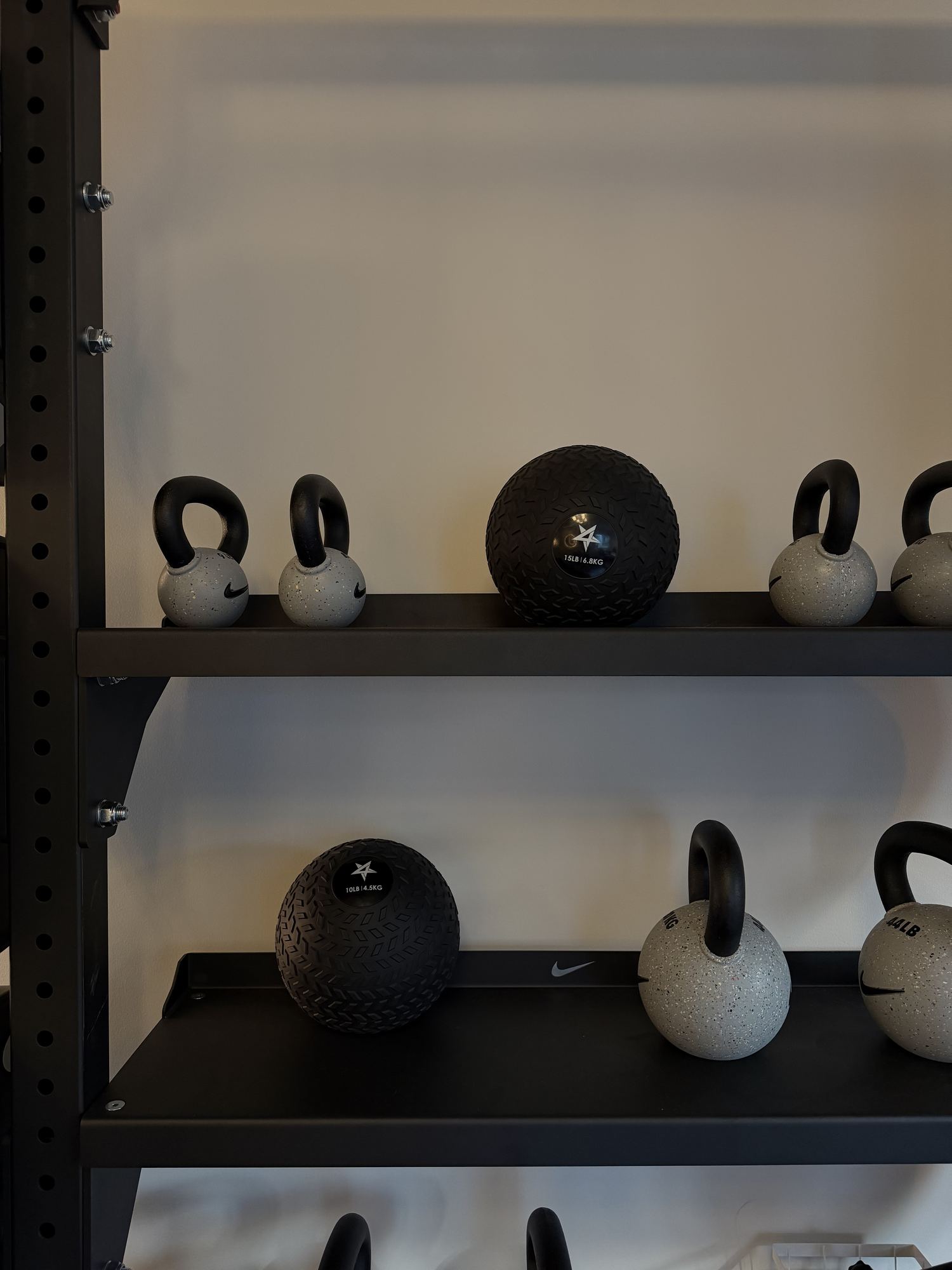 Kettlebells and medicine balls on the shelves